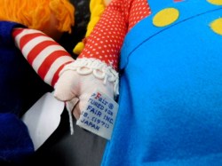 2 cloth dolls label a